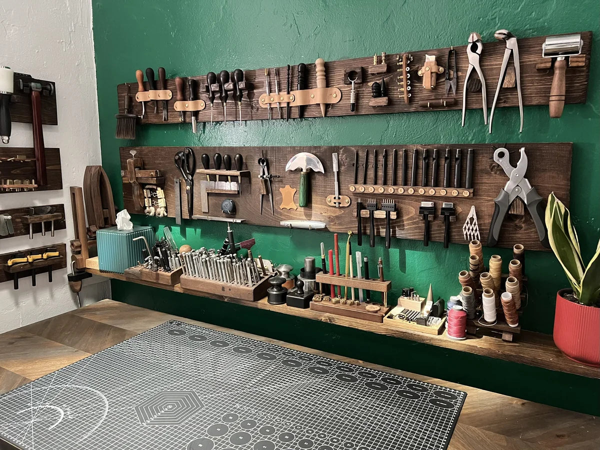 Perspective view of the complete leather crafting workbench and organized hand tools setup at Deco Leather Studio.