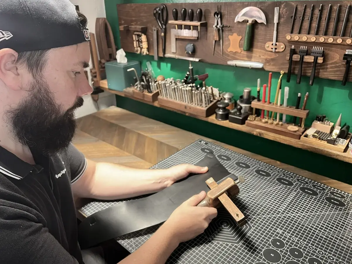 Cutting a leather strap at the bench